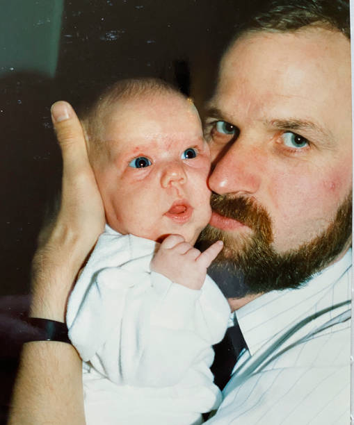 Young father back in time Happy young father holding the new born baby, back in time father daughter 80s stock pictures, royalty-free photos & images