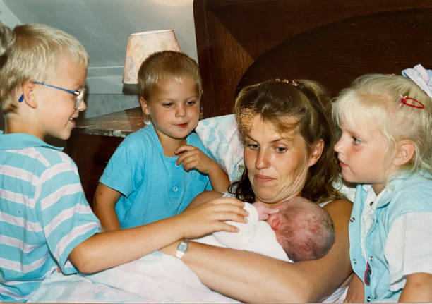 Young family with new born baby back in time Happy young family back in time with new born sibling father daughter 80s stock pictures, royalty-free photos & images