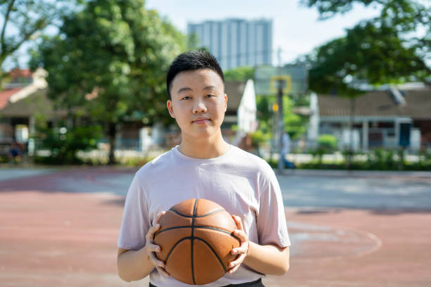 istock Man holding soccer ball looking at camera. 1468746654