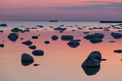 Twilight sunset on the shore of the Baltic Sea. Rocky coast.