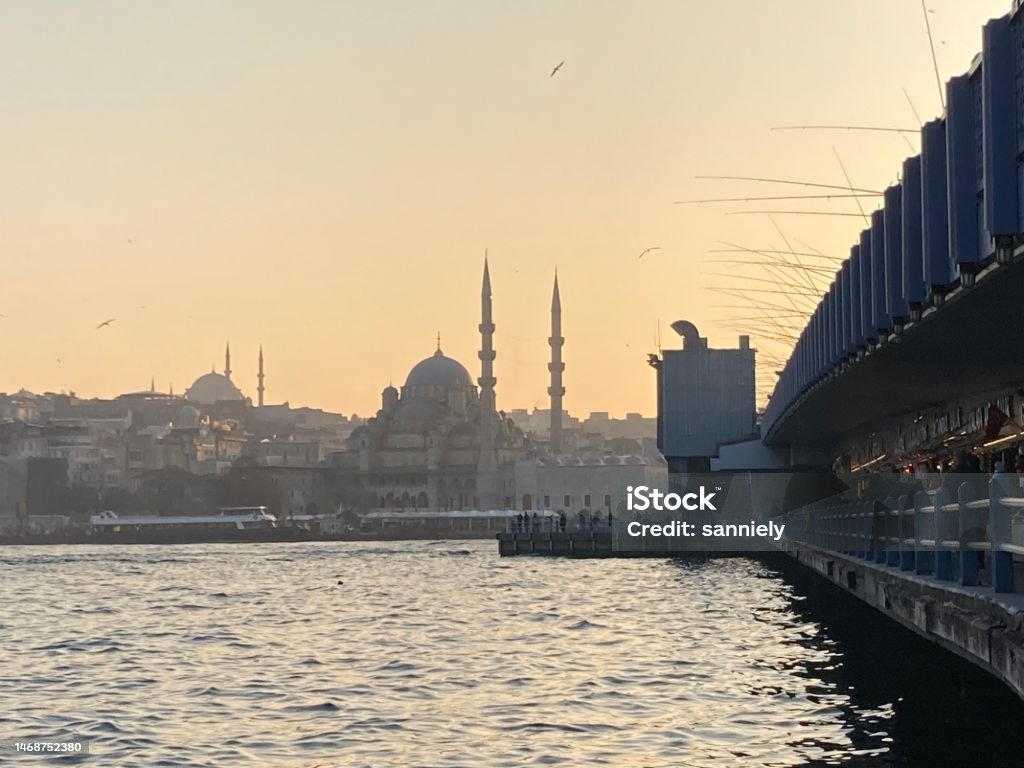 Turkey - Istanbul - Galata Bridge with fisherman and Yeni Cami Mosque Architecture Stock Photo