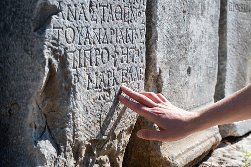 Archaeologist Examines Ancient Greek Inscriptions