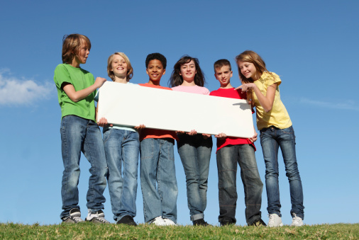 diversity, group of diverse kids, youth tweens or children holding blank sign, poster placard or banner