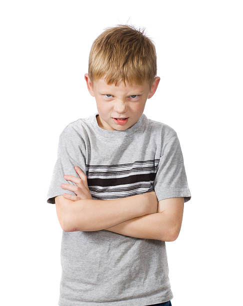 istock angry young boy with arms crossed 146875477