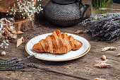 Baked croissant bun on the wooden table