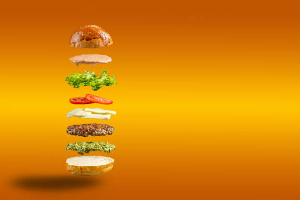 istock Floating burger ingredients on the yellow background 1468760053