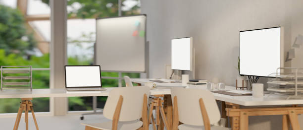 istock Modern minimal office co-working room with PC computers and laptop mockup 1468760073