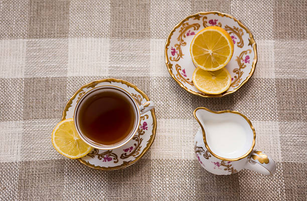 Tea with lemon and milk stock photo