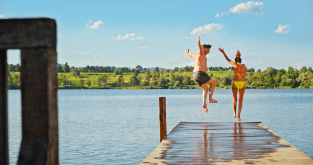 istock Couple jumping in lake 1468763918