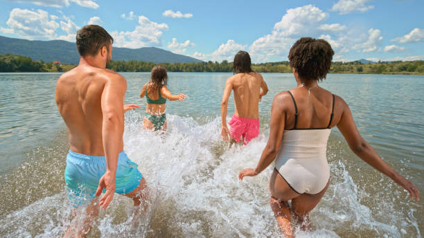 friends enjoying in lake - black blue escape multi colored imagens e fotografias de stock