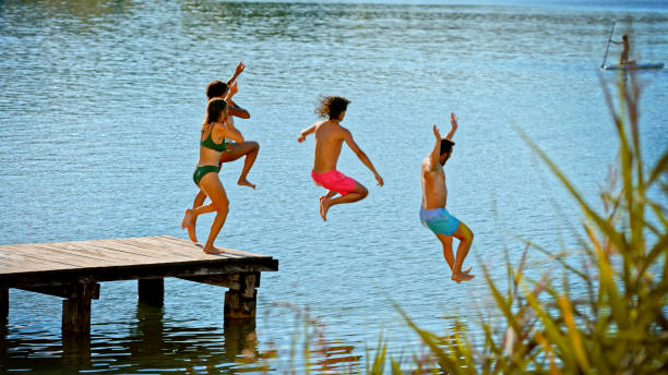 istock Friends jumping in lake 1468763964