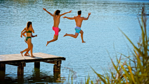 istock Friends jumping in lake 1468763974