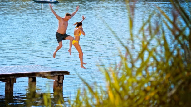 istock Couple jumping in lake 1468763978