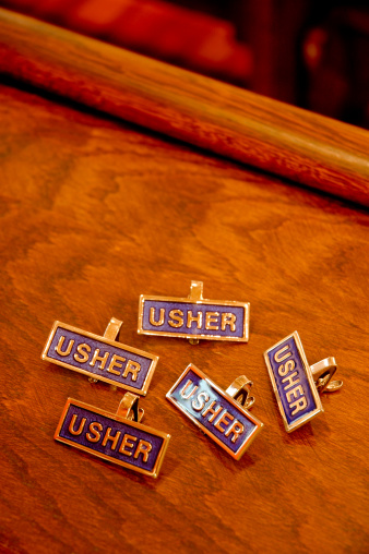 This is a photo of the church usher tags sitting together on a table.