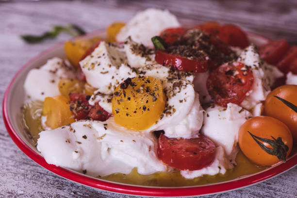 Close up of a Mozzarella and Tomato Caprese salad on a kitchen table