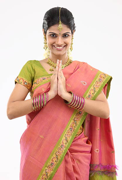 Woman in pink silk sari posing welcome stock photo