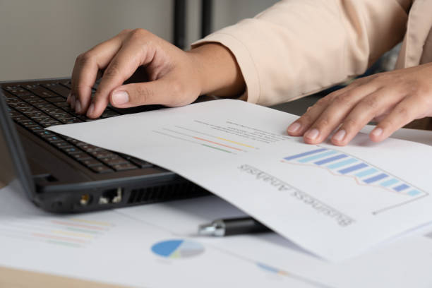 istock Business woman working for budget or report graph document paper on desk 1468767020