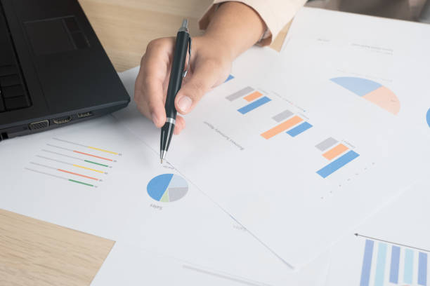 istock Business woman working for budget or report graph document paper on desk 1468767727