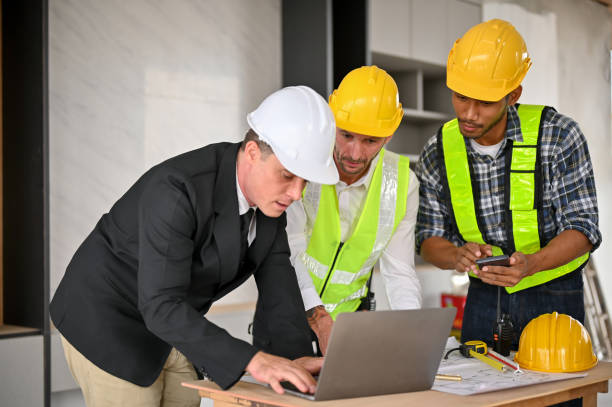 istock Caucasian businessman using laptop while meeting with a team of construction engineers 1468767776