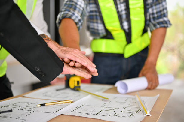 istock Cropped image of a team of construction workers putting their hands together over the table 1468767895