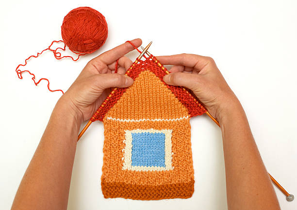 A red and orange knitted house stock photo