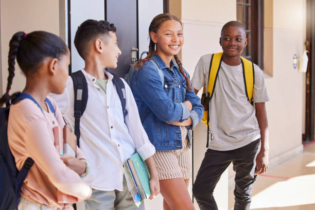 istock Education, school and students with books and diversity waiting outside class with learning and development. Academic, primary school campus and happy children smile and ready to learn at academy. 1468771964