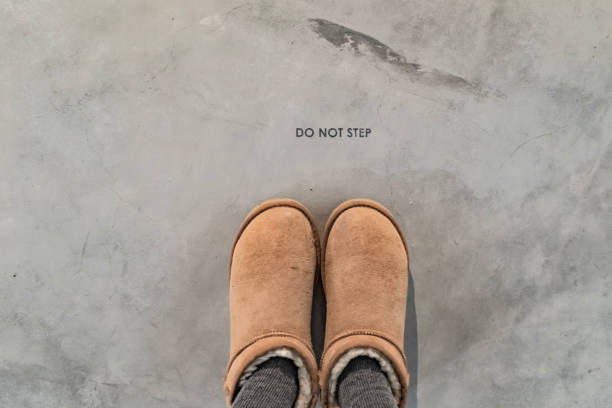 see the do not step reminder on the ground - moonboots imagens e fotografias de stock