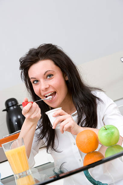 istock woman making breakfast with yogurt,and fruit 146877349