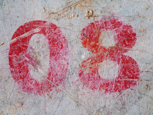 Black number 8 on a white concrete background.