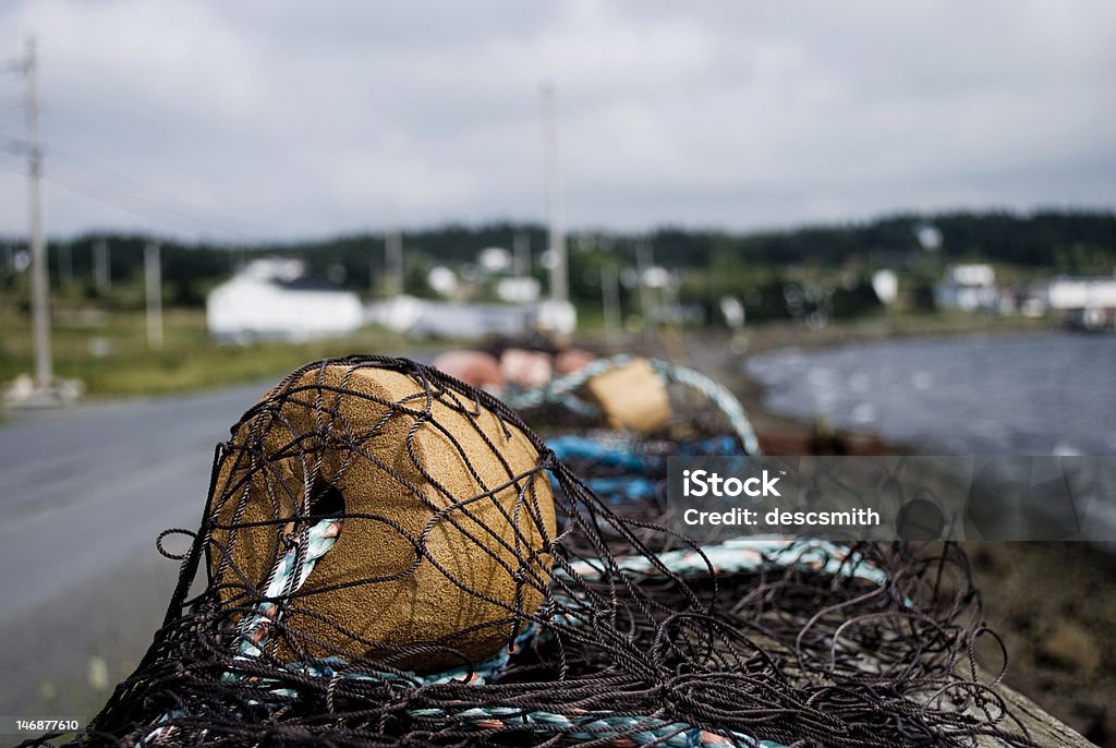 Old Fishing Net Fishing nets drying along the side of the road in Newfoundland. Commercial Fishing Net Stock Photo