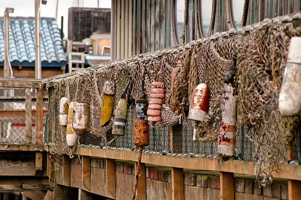 Old buoys and netting used as decoration for the outside of a sea food restaurant
