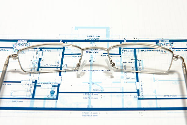 Blueprint for a house and eyeglasses stock photo