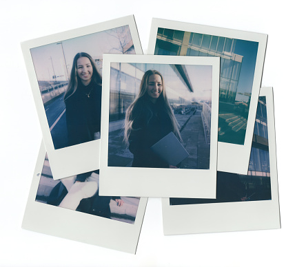 A pile of instant photo prints of a fashionable young businesswoman in the city on a sunny winter day. Photographs taken with an instant film camera.