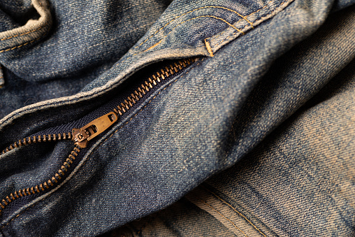 Part of dark jeans.  Textile texture. Design concept. Top view.