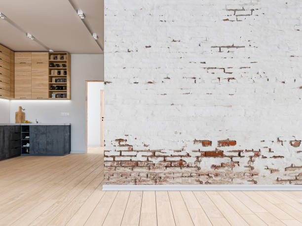 istock Empty living room with a large ruined plaster and brick wall and a modern kitchen  in the background 1468784212