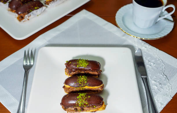 istock Eclairs with chocolate topping, delicious chocolate small cake, 1468786580