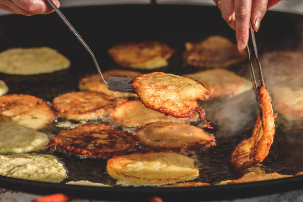 istock Frying traditional blini, blin or bulviniai blynai, potato pancakes 1468787064