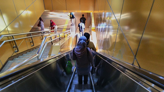 people walk down the stairs at gondangdia station, jakarta, indonesia, 25 october 2022
