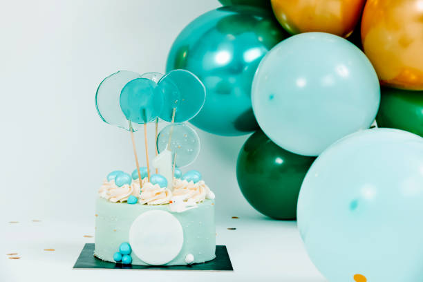 istock blue cake and balloons of different colors 1468788767