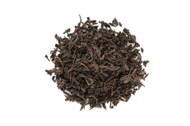 istock Dry tea leaves isolated on white background. Top view 1468789662