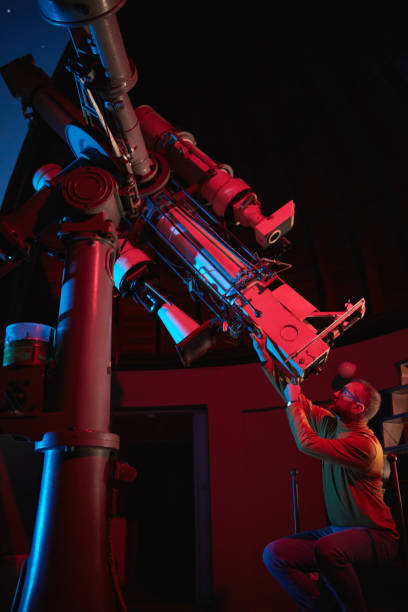 istock Astronomer with a big astronomical telescope in observatory doing science research of space and celestial objects. 1468789787