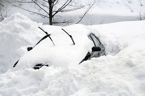 Photo of Car buried under large snowdrift