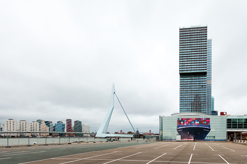 Part of the Rotterdam skyline is formed by modern landmarks that were realised during the past 25 years. The Erasmus Bridge spans the river Nieuwe Maas and is surrounded by buildings like the Maastoren,  tower Wilhelminahof, Court of Justice, Luxor Theatre, KPN office Belvédère and De Rotterdam, one of the largest buildings in The Netherlands. Most of these iconic landmarks were realised in the Kop van Zuid quarter.