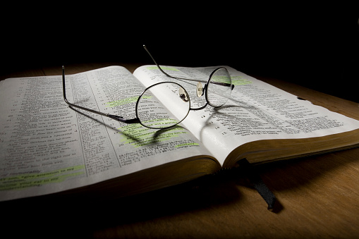 wide angle shot of eye glasses on an open bible