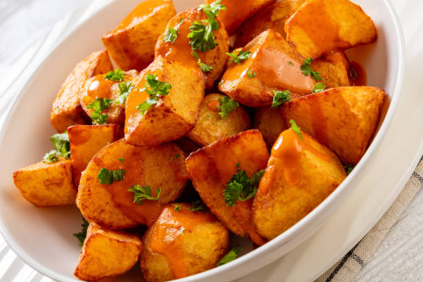 istock patatas bravas, deep fried potatoes with sauce 1468798819