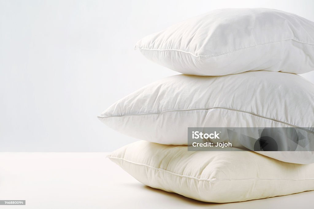 Pile of pillows A pile of three white pillows. White background. Pillow Stock Photo