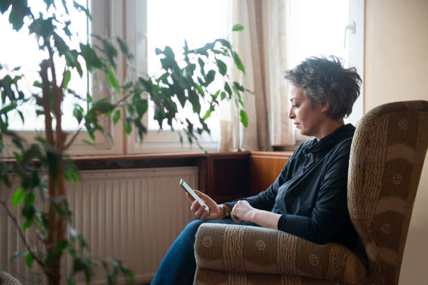 istock Woman using mobile phone at home 1468803258