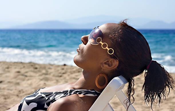 istock Young black woman sunbathing 146880500
