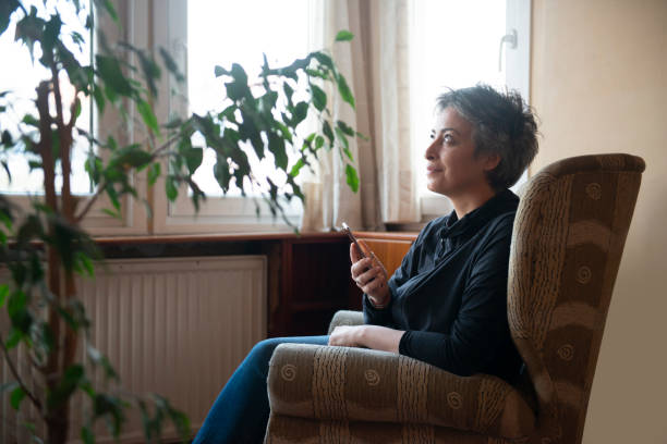 istock Woman using mobile phone at home 1468805811