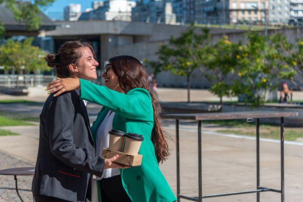 istock Two business colleagues hugging while meeting outdoors. 1468806883